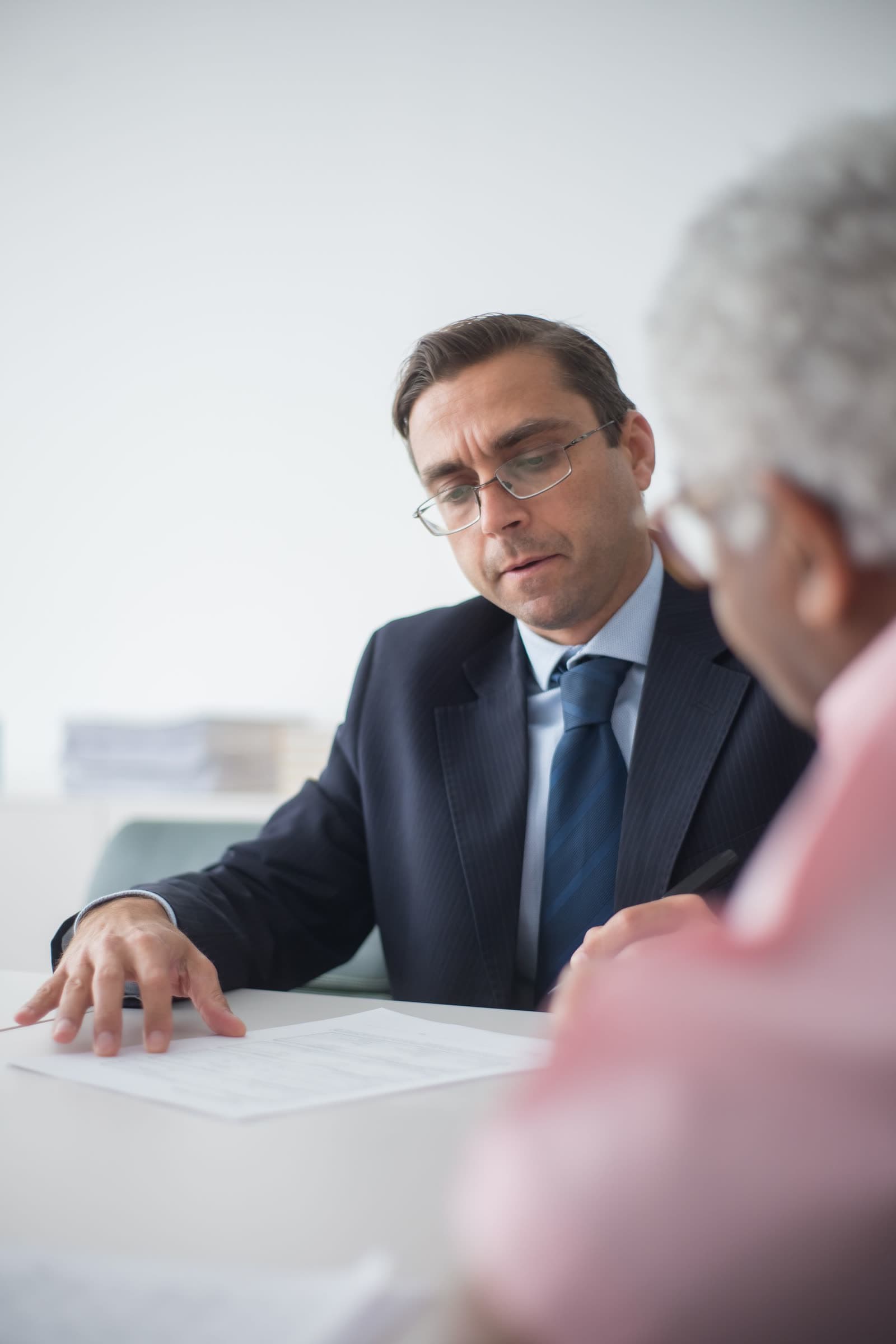 An adviser going through a form with a client at a desk